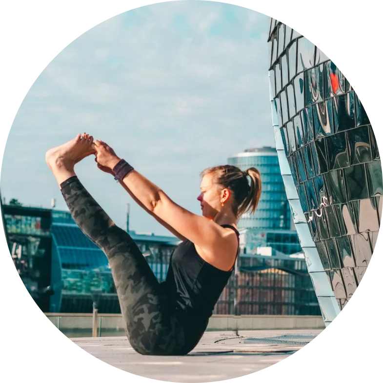 Martha, certified yoga instructor, demonstrating a Vinyasa pose in outdoor area